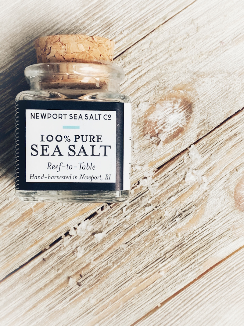 A jar of Newport Sea Salt on a white washed board